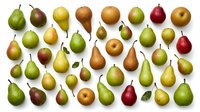 Collection of fresh pears in various colors and sizes arranged on white background. Organic fruit assortment perfect for healthy eating concepts.