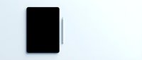 Black tablet device with stylus pen on clean white background for technology and digital design projects.