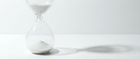 Hourglass with flowing sand on white background, symbolizing time passage, deadline, and urgency for business and conceptual projects.