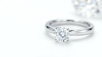 Elegant diamond solitaire engagement ring with brilliant cut stone on platinum band against white background for wedding and jewelry designs.
