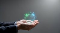 Businessman hands holding glowing digital earth globe with renewable energy icons floating above palms representing sustainable technology and green business solutions.