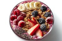 Healthy breakfast bowl with acai smoothie, granola, fresh berries, banana slices and chia seeds on white background. Nutritious morning meal.