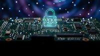 Cybersecurity concept with glowing padlock hologram over computer circuit board representing data protection and digital security technology.