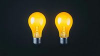 Yellow glowing light bulbs on dark background, illuminated filament lamps with metallic base showing creative thinking and bright ideas concept.