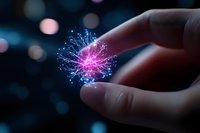 Glowing magical light particle floating above fingers against dark background with bokeh lights, creating mystical and futuristic atmosphere.