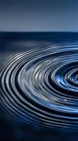 Concentric water ripples creating circular waves on calm blue surface with smooth gradient background for meditation and wellness concepts.