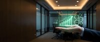 Businessman hand holding tablet displaying green growth chart with gears and upward arrow graph in modern office conference room with glass partitions and ambient lighting.