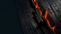 Charred wood surface with glowing orange embers and flames creating dramatic texture for fire safety and destruction concepts.