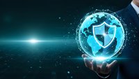 Businessman hand holding glowing digital globe with security shield icon representing global cybersecurity and data protection technology solutions.