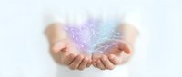 Female hands cupping glowing purple and blue energy light with ethereal wisps on white background for healing, spirituality and wellness concepts.