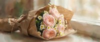 Soft pink peony roses and white daisies wrapped in kraft paper, placed by a sunny window in a delicate painted style.