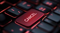 Red cancel key on dark gaming keyboard with illuminated edges, symbolizing error correction, deletion, or system abort functions for technology and digital interface concepts.