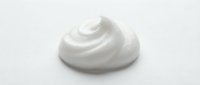 Isolated white cream or lotion swirl on neutral background, ready for cosmetic, skincare, and beauty product design applications.