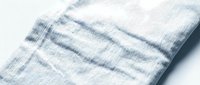 Folded linen fabric with blue stripes on white background, suitable for textile, home decor, and product photography.
