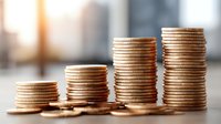 Golden coins stacked in ascending columns representing financial growth, savings progress, investment returns and wealth building concept.
