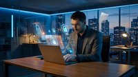 Young businessman working with holographic digital interface technology in modern office at night with city skyline view through windows.