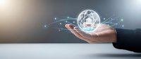 Business professional holding glowing digital network sphere with connected nodes representing global connectivity and technology innovation concepts.