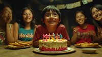 Young Asian boy smiling with birthday cake surrounded by family members at celebration party, warm lighting creates nostalgic mood, candlelit cake centerpiece with cookies.