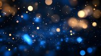 Magical blue and gold bokeh lights on dark background create dreamy atmosphere with glowing particles and blurred circles for festive designs.