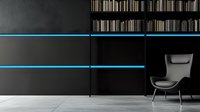 Modern minimalist interior with black wall panels featuring glowing blue LED strips, contemporary gray armchair against dark backdrop, concrete floor.