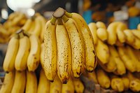 Fresh ripe bananas with brown spots at local market, healthy tropical fruit for sale at grocery store or farmer's market.
