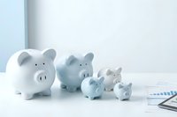 Family of piggy banks in different sizes representing savings growth and financial planning for budget management and investment goals.