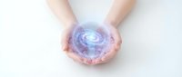 Hands holding glowing digital spiral energy sphere with blue purple light effects for technology innovation and futuristic concepts.