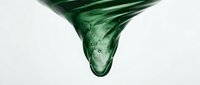 Green viscous liquid dripping downward with bubbles against white background, perfect for skincare, cosmetics, and natural product designs.