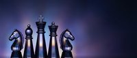 Chess pieces on dark purple background with dramatic lighting for strategic business concepts and competitive planning presentations.