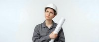 Young male construction worker or architect wearing white hard hat and gray work shirt, holding rolled blueprints, isolated on white background for design projects.
