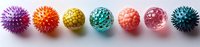 Colorful massage spiky rubber balls in row on white background. Sensory and stress relief toys for children and adults. Physiotherapy equipment.