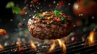 Juicy beef burger patty grilling over open flames with falling spices, herbs and peppercorns against dark background. Gourmet food preparation.