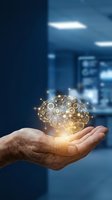 Hand holding glowing digital brain with network connections representing artificial intelligence and innovation in modern office environment.