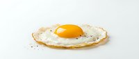 Fried egg with golden yolk and crispy edges isolated on white background. Fresh breakfast food ingredient for cooking and culinary designs.