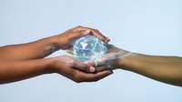 Two diverse hands holding glowing crystal sphere with blue light energy, symbolizing teamwork, innovation, and shared vision for future technology and collaboration.