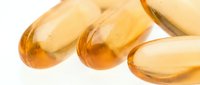 Translucent golden capsules containing liquid supplement or vitamin oil, suitable for healthcare, wellness, nutrition, and pharmaceutical marketing materials.