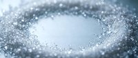 Sparkling white granules form a circular frame around empty center space, creating abstract texture with bokeh light effects and shallow depth of field.