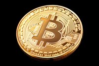 Golden cryptocurrency coin with bitcoin symbol on black background, detailed macro shot showing metallic texture and reflective surface. For finance and tech designs.