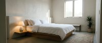 Modern minimalist bedroom with floating wooden bed frame, white bedding, and natural lighting creating serene sleeping space for interior design.