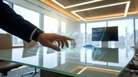 Businessman hand touching digital holographic interface with data visualization and cityscape view through office windows, representing technology innovation and business analytics.