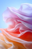 Smooth flowing fabric waves in soft gradient colors from white to pink and coral orange create abstract organic shapes against light blue background.