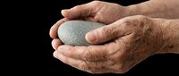 Elderly hands cupping a smooth gray stone, isolated on transparent background. Ready for wellness, meditation, and mindfulness clipart, stickers, and print on demand designs.