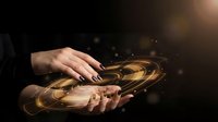 Hands holding glowing golden light energy swirling in palms against dark background, representing magic, healing, spirituality, and power for wellness and mystical concepts.