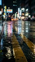 Wet city street at night with glowing neon reflections on rain-soaked asphalt, yellow road markings, and blurred bokeh lights in the background.