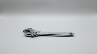 Single adjustable wrench tool isolated on white background for mechanical repair work and construction projects.