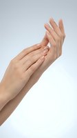 Woman hands applying moisturizer cream on white background. Skincare routine, beauty treatment, hand care concept for cosmetic advertising.
