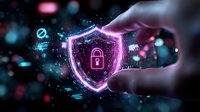 Hand holding glowing digital security shield with lock icon surrounded by cyber protection elements and data particles on dark tech background.