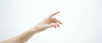 Female hand with elegant gesture pointing forward on clean white background isolated for design projects and presentations.