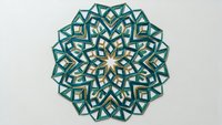Intricate mandala design with teal and gold geometric patterns on white background, isolated ornamental motif for meditation and spiritual decor projects.