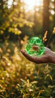 Hand holding glowing green recycling symbol in sunlit forest representing environmental conservation and sustainable living practices for eco-friendly campaigns.